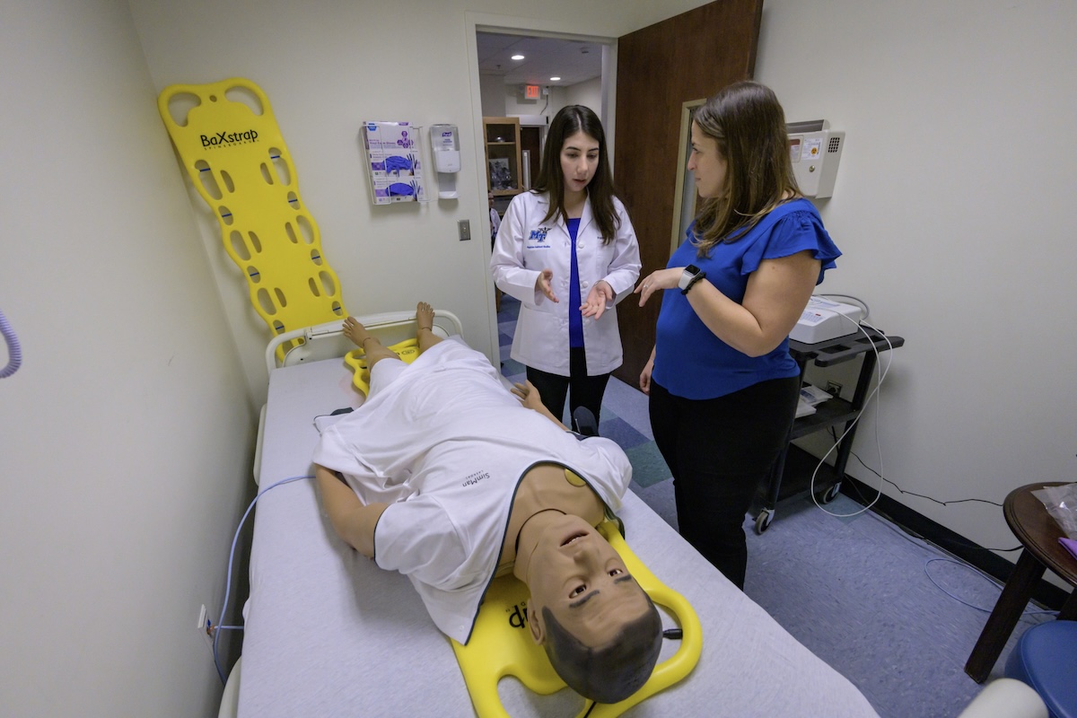 An MTSU Physician Assistant student and instructor in a lab.