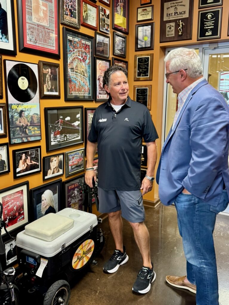 Eric Blankenship, left, co-owner of All Access Coach Leasing, talks with Colby Jubenville, director of the Center for Student Coaching and Success at Middle Tennessee State University, at All Access Coach Leasing in Gallatin, Tenn.